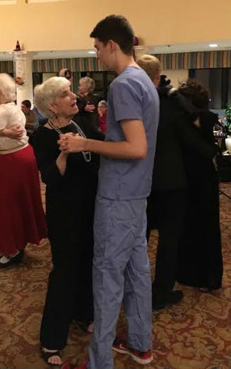 NHS Memeber, Troy Schleich dancing with a memeber of the Dublin Retirement Village.
