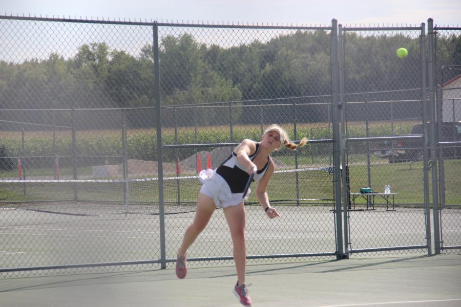 Grove+concentrates+on+her+swing+as+she+sends+the+ball+over+the+net.+