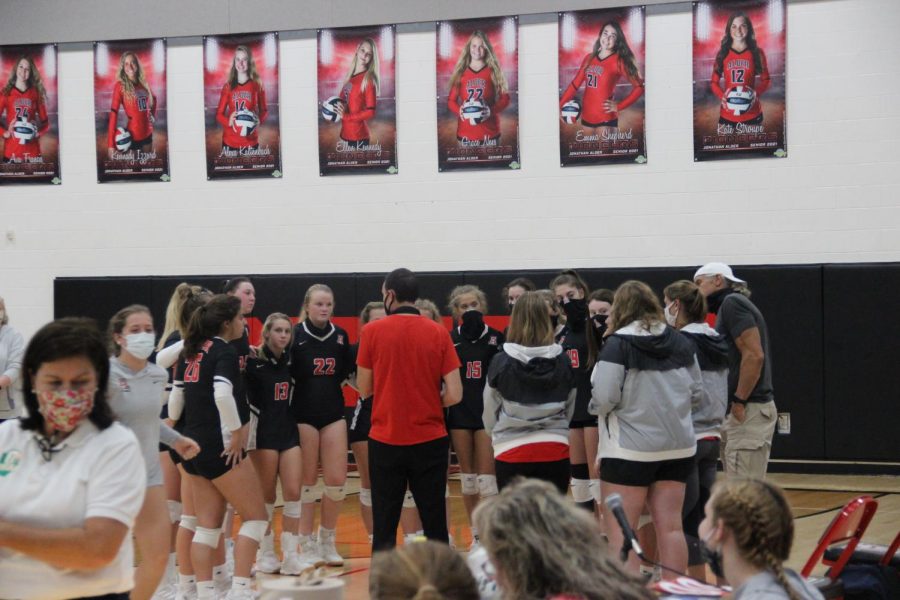 The volleyball team gathers in a timeout during their game against Kenton Ridge. 