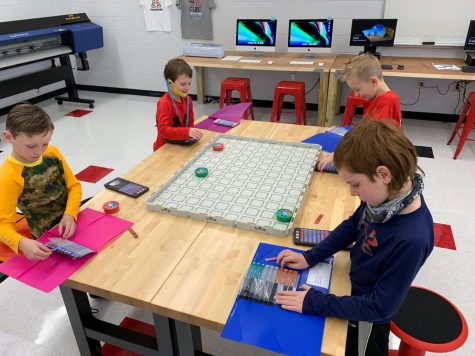 Students in the lab learning and playing with coding materials.