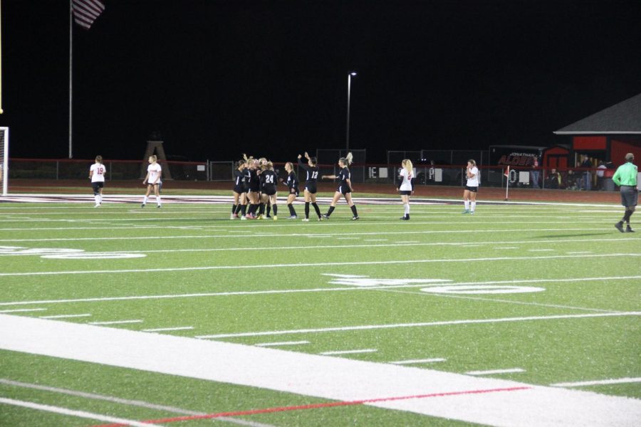 The team celebrates after scoring their first goal early in the game.
