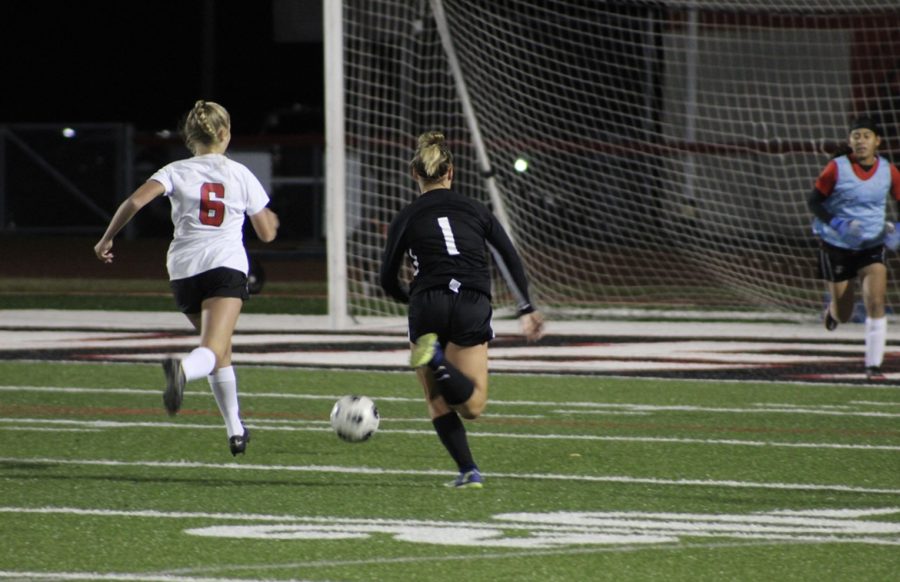 Sophomore Peyton Sifrit chases the ball towards the goal.
