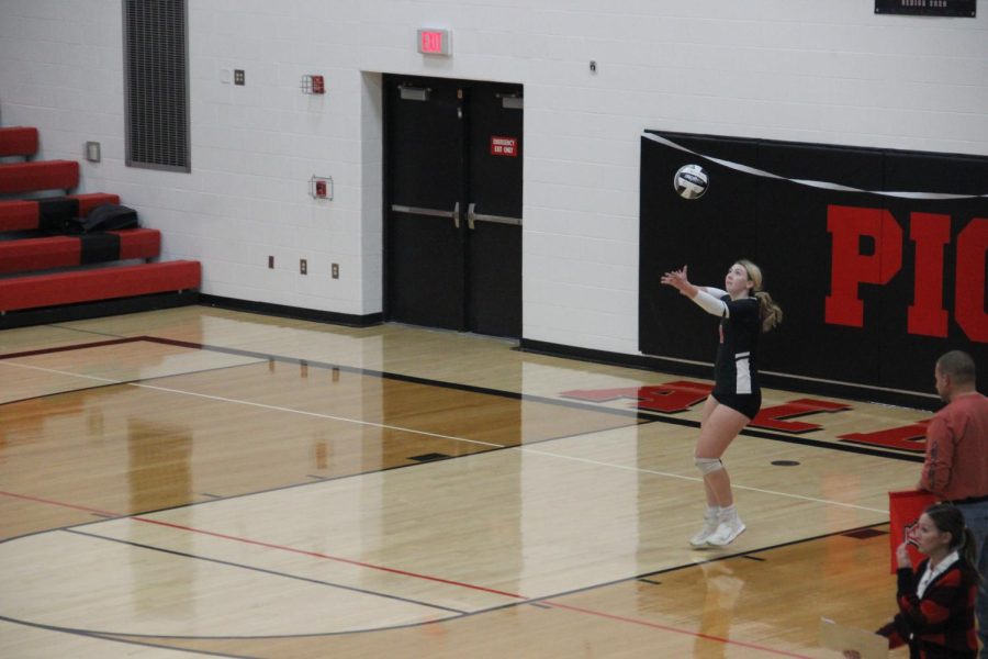Olivia Crabtree serves the ball.