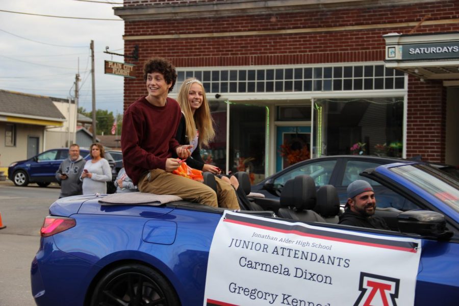 Junior attendants Carmela Dixon and Gregory Kennedy  pass by the crowd during the parade.