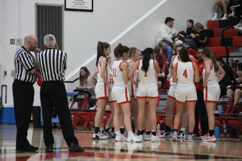 JAHS Girls Basketball in  huddle during a time-out. 
