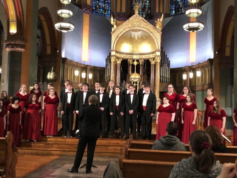 Students warm up before preforming at Saint Paul the Apostle.