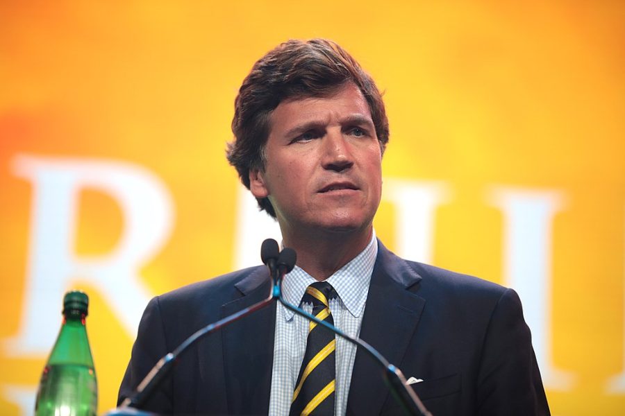 Tucker Carlson speaks at an event. 