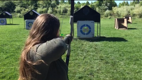 Junior, Edden Eisan shooting her bow.