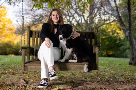 Beach poses with her dog in her senior pictures. 