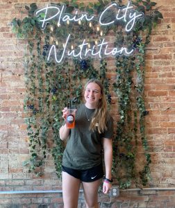 PCN Owner, Hayley Jaskiewicz poses for her picture in front of the photo wall.