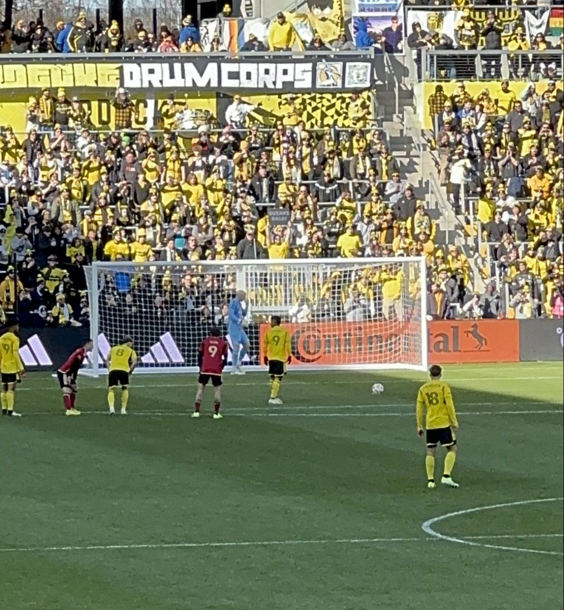 The Crew players line up for a penalty shot, with Cucho Hernandez preparing to take the shot.