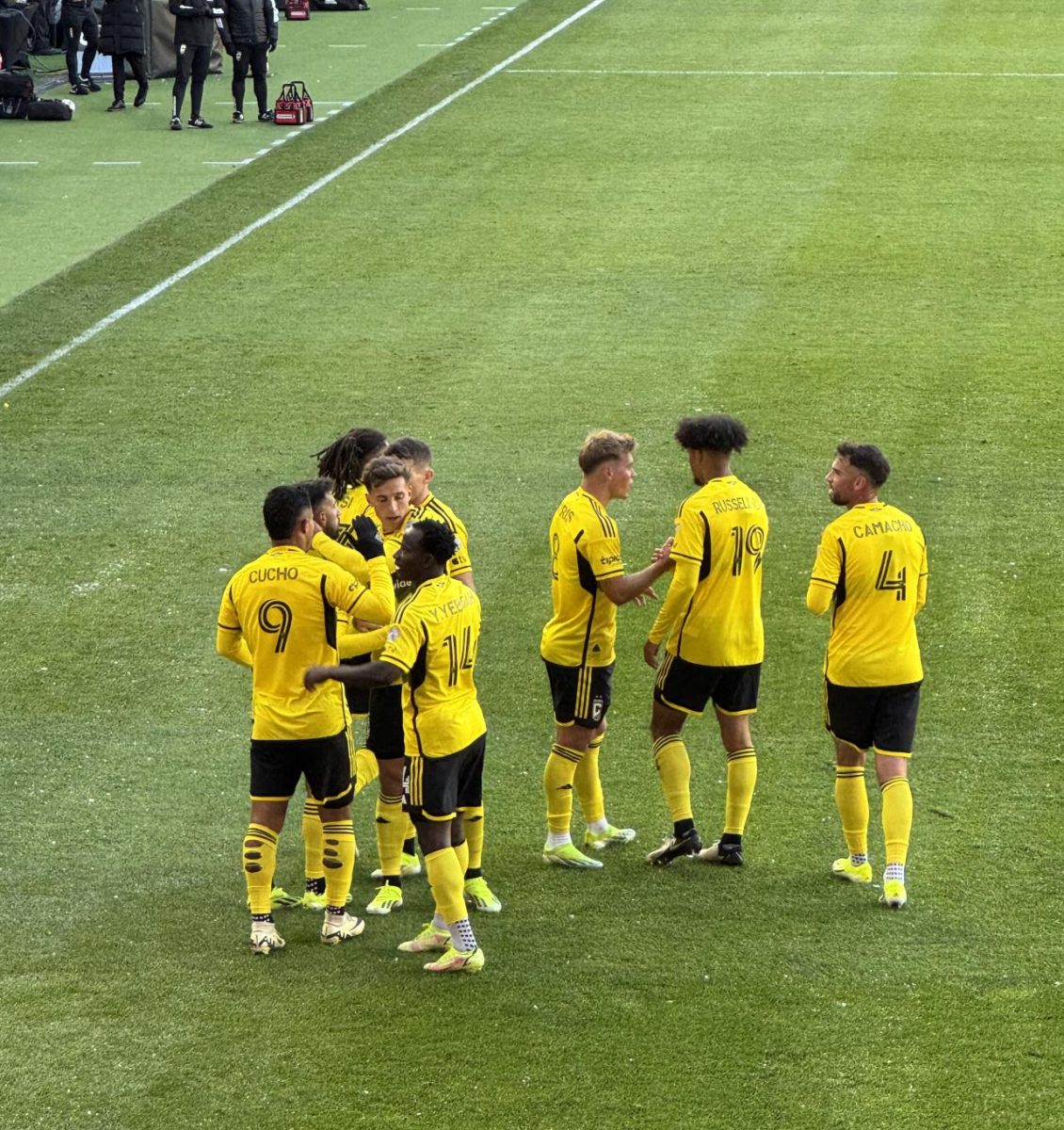 Columbus Crew players join together and celebrate a goal. 