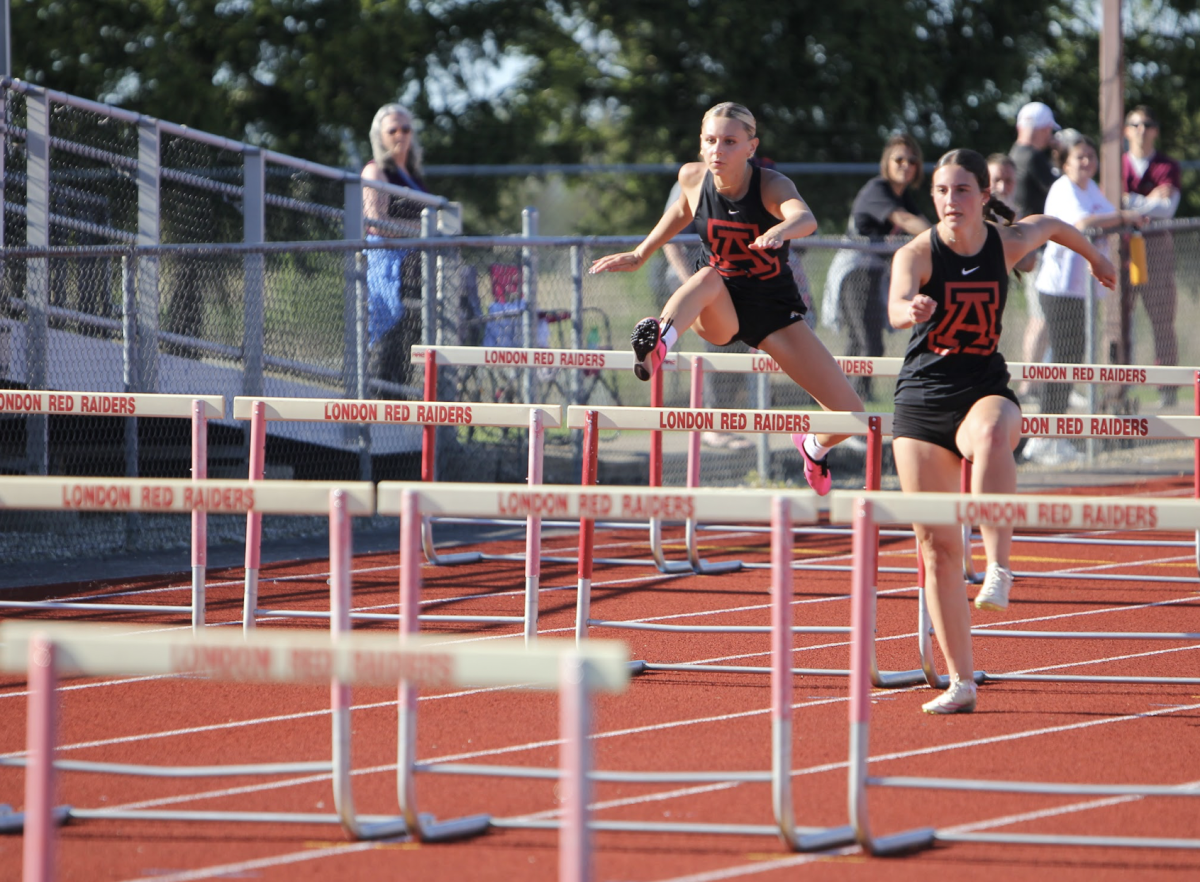 Senior Allie Piccolantonio leaps over the hurdle. 