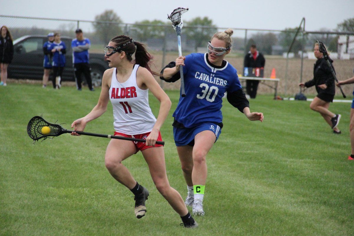 Junior Ally Gearheart from Fairbanks High School sprints in front of opposing team player. Since girls lacrosse is a club sport, it is open to students from neighboring schools.
