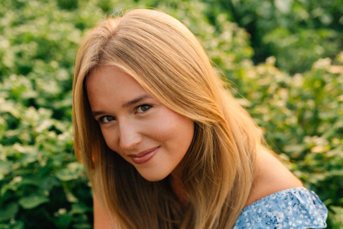 Anna Engle sitting a patch of greenery. Photo courtesy of Anna Engle