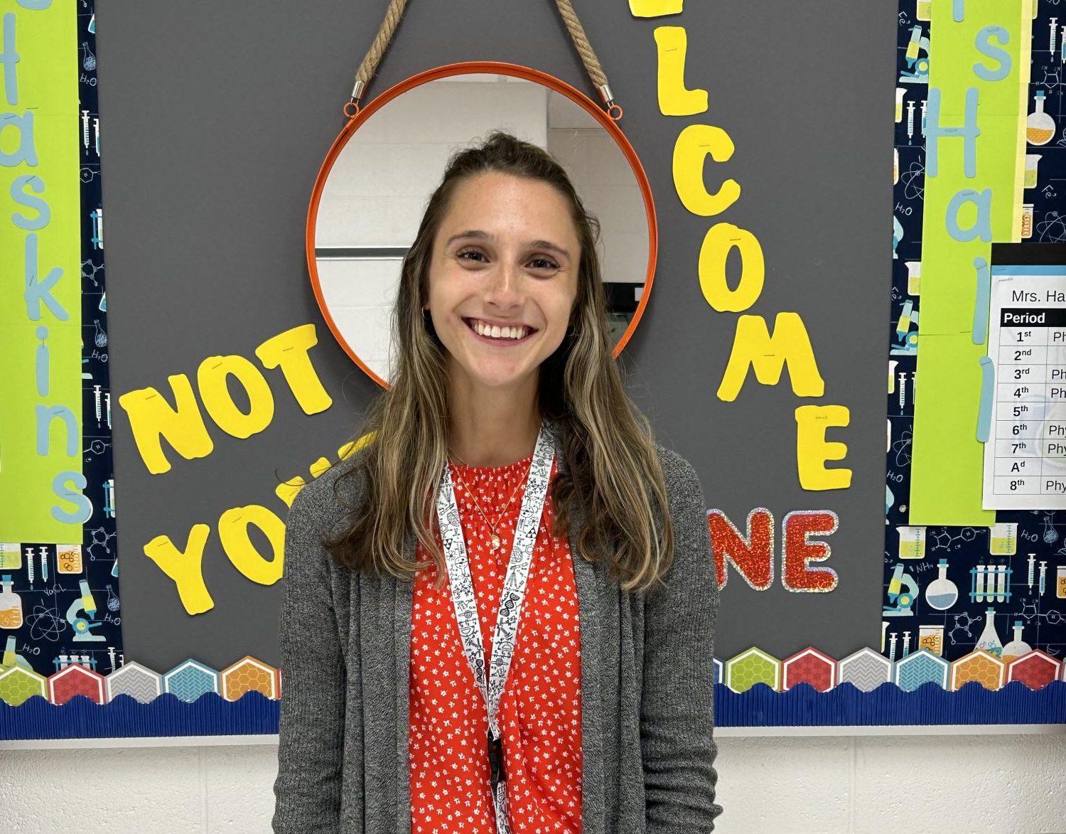 Ms. Haskins poses for a photo outside of her classroom. 