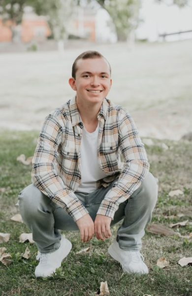 Jason Thompson poses in a field for his senior photo. 

Photo courtesy of Jason Thompson