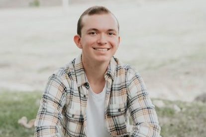 Jason Thompson poses in a field for his senior photo. 

Photo courtesy of Jason Thompson