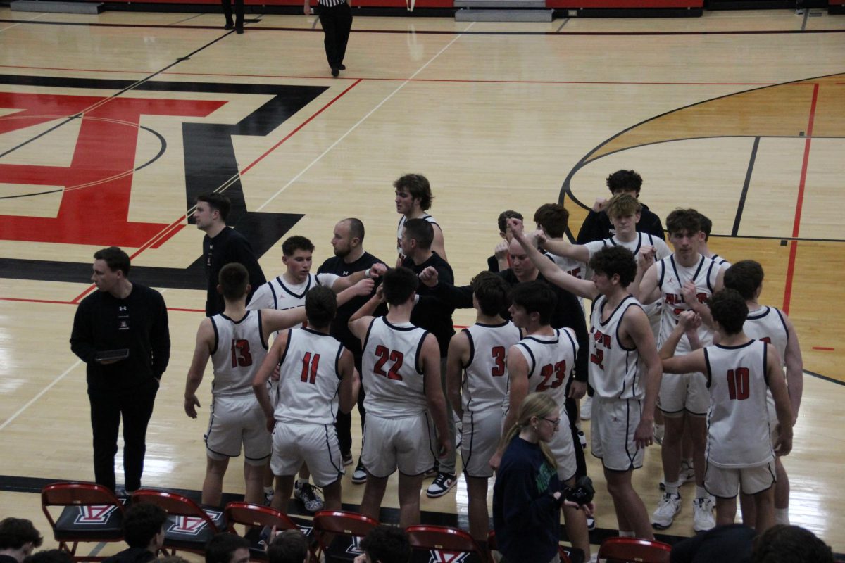 Alder huddles while coach Scott Heiss gives them pointers.