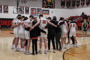 Alder huddles before the game while their coach gives them a preparation speech.