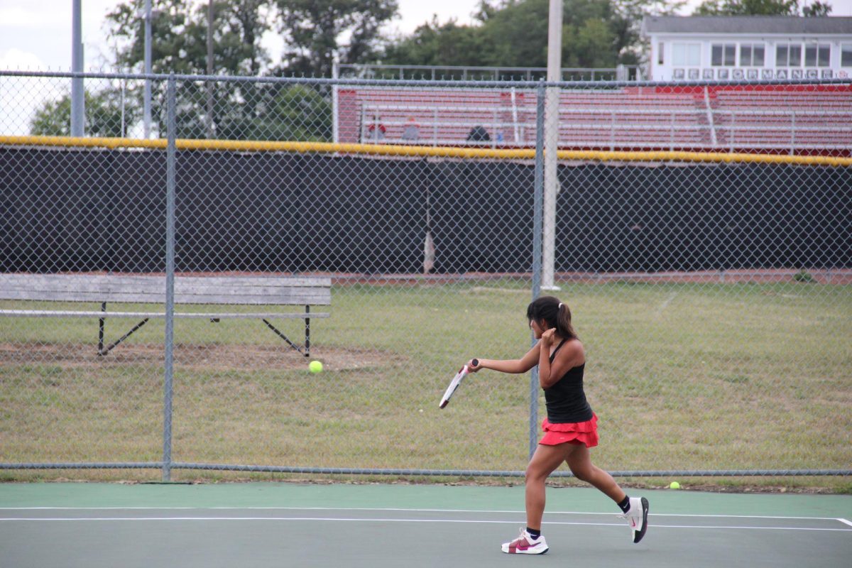 Senior Estrella Flores-Villanueva returns a hit.