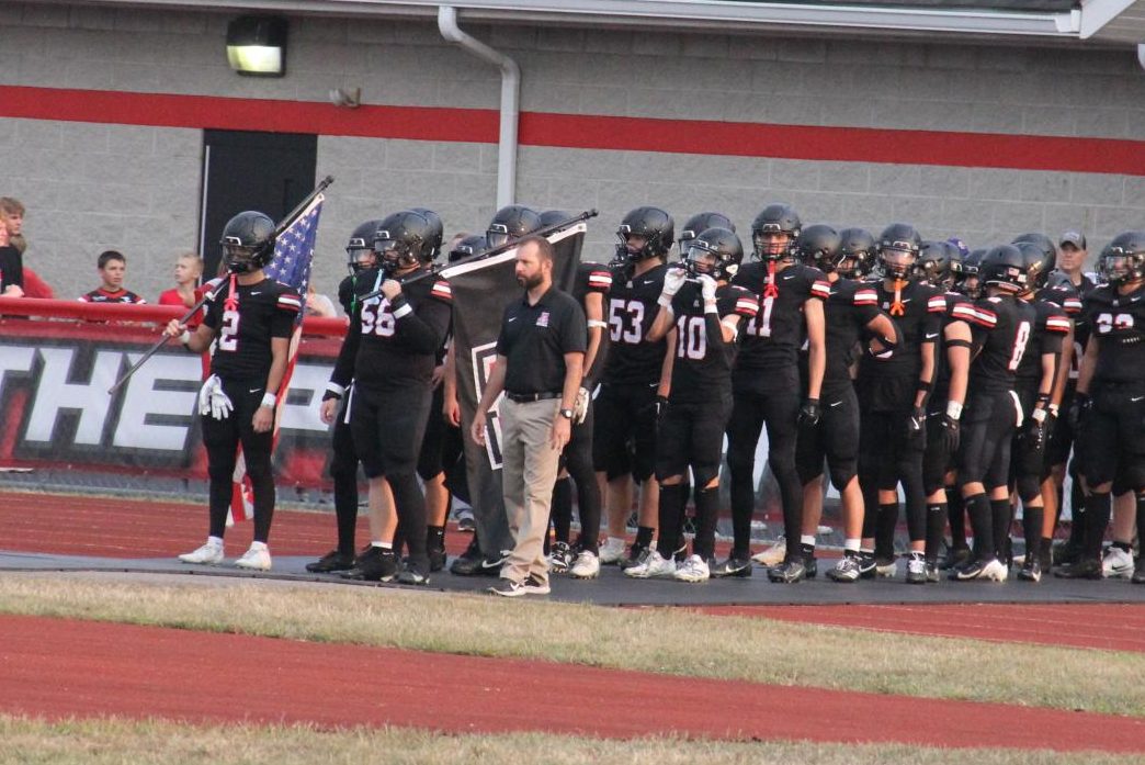 Brett Glass with the football team before a game. 