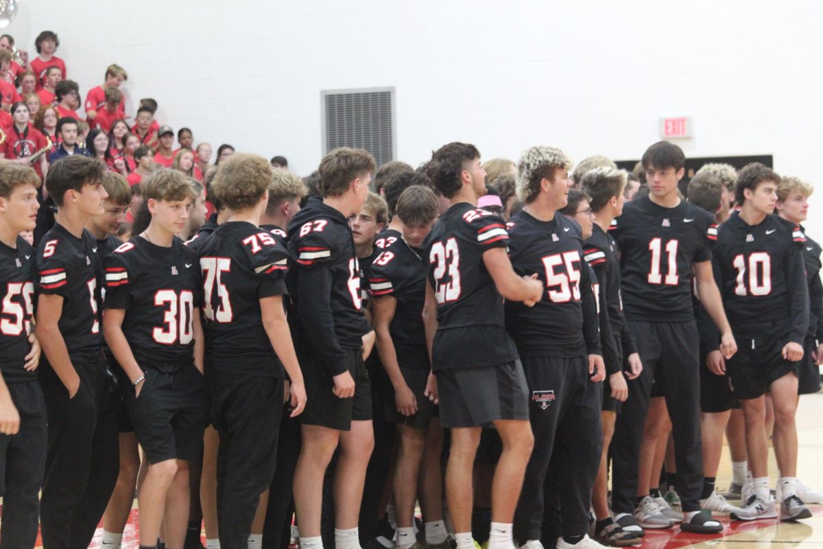 Football team lined up for recognition during the pep rally.