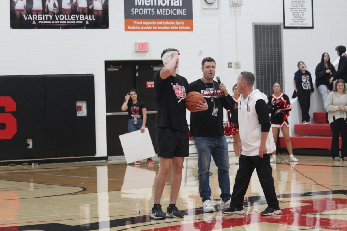Garrett Bauer prepares to shoot into the hoop blindfolded for a chance to win $1,000 dollars.