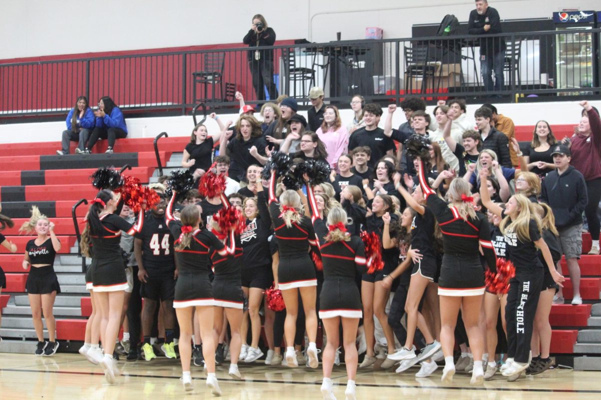 Seniors cheer in the spirit stick competition.