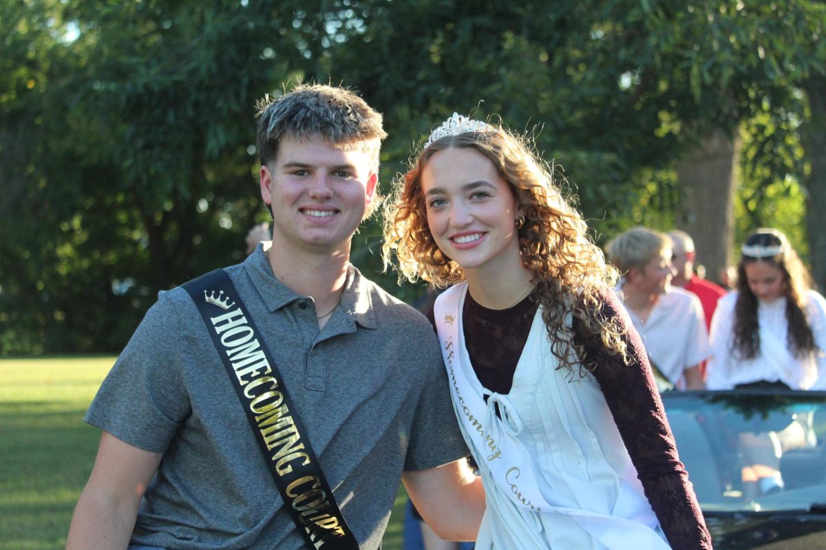 Our second member of the senior court, Emerson Edwards, who is escorted by Garrett Bauer.