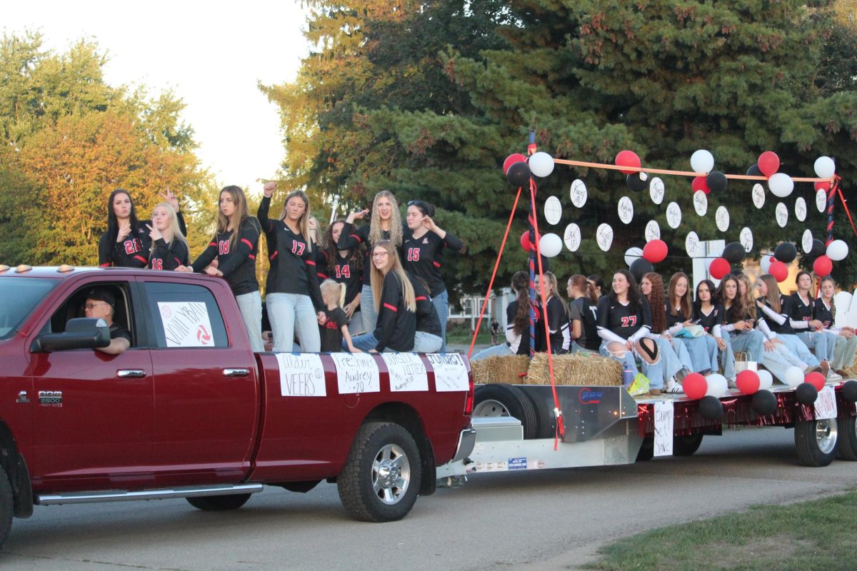 The varsity volleyball team throws candy to parade watchers