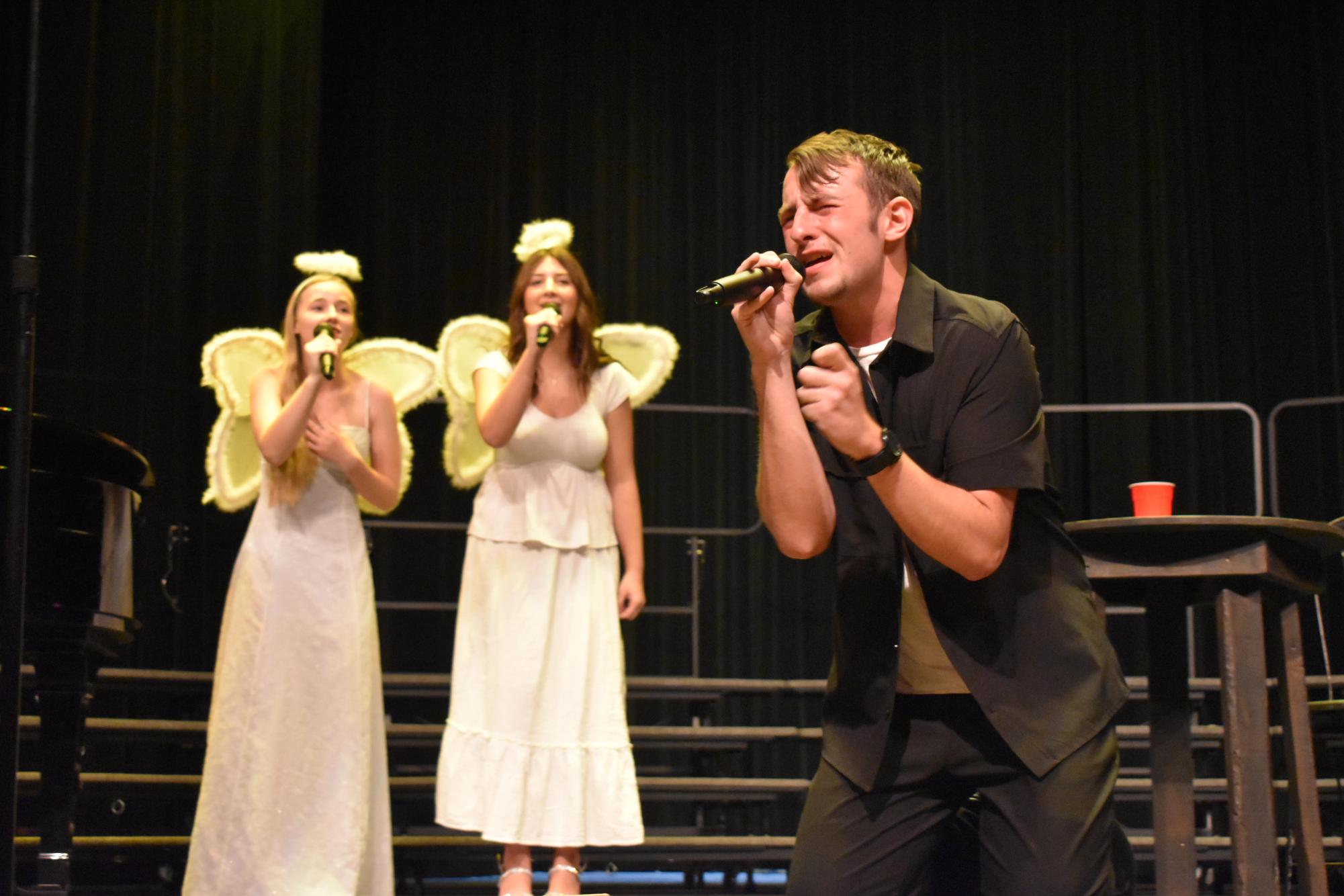 Senior first place winner Jason Dietry performing "Pizza Angel" from "Veggie Tales" with junior Evelyn Simmons and sophomore Ruthie Sebestyen. 

Photo courtesy of yearbook staff member Caroline Kerr.