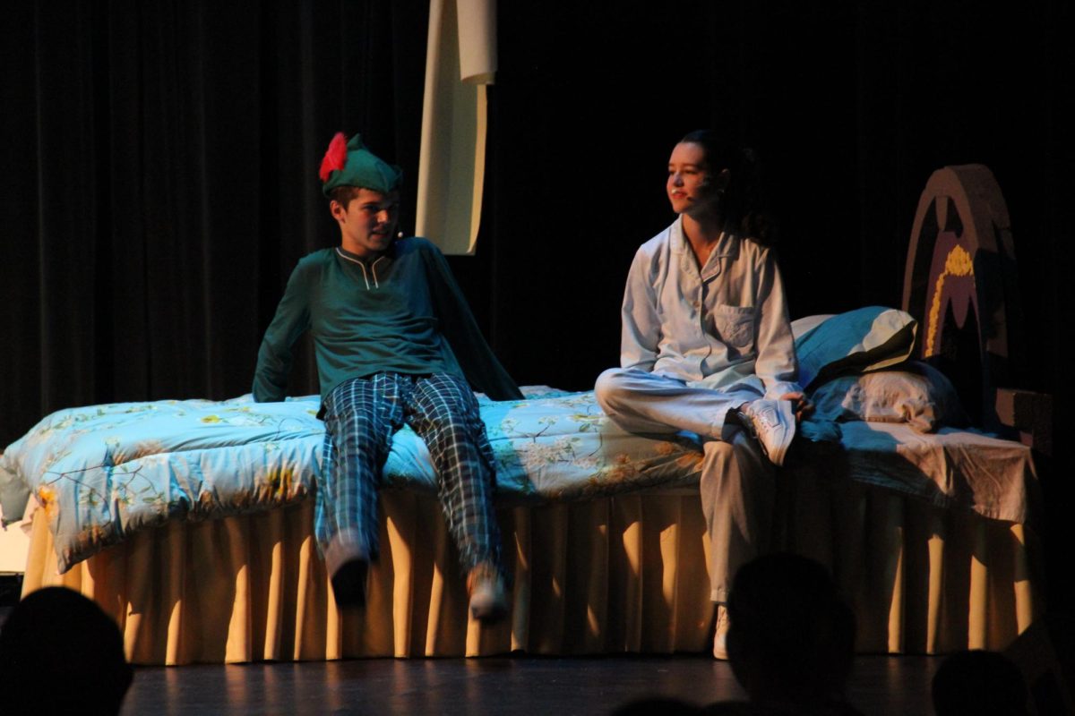 Peter Pan (Gregory) sits with Wendy (McCabe).