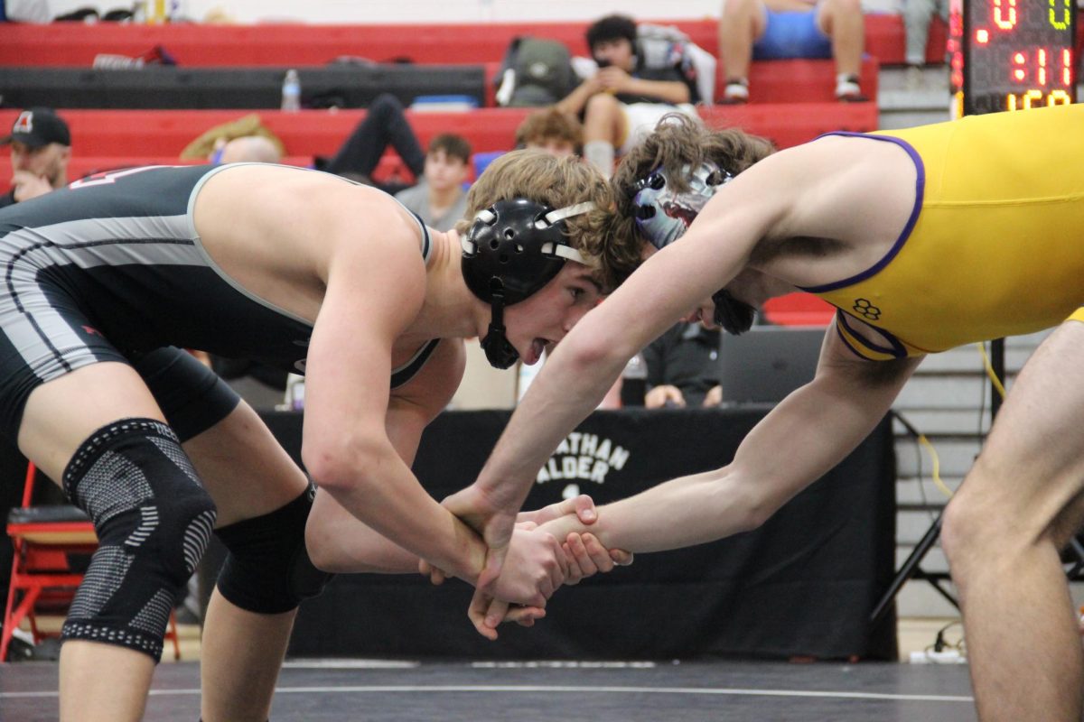 Senior Aiden Ricker wrestles his opponent. 