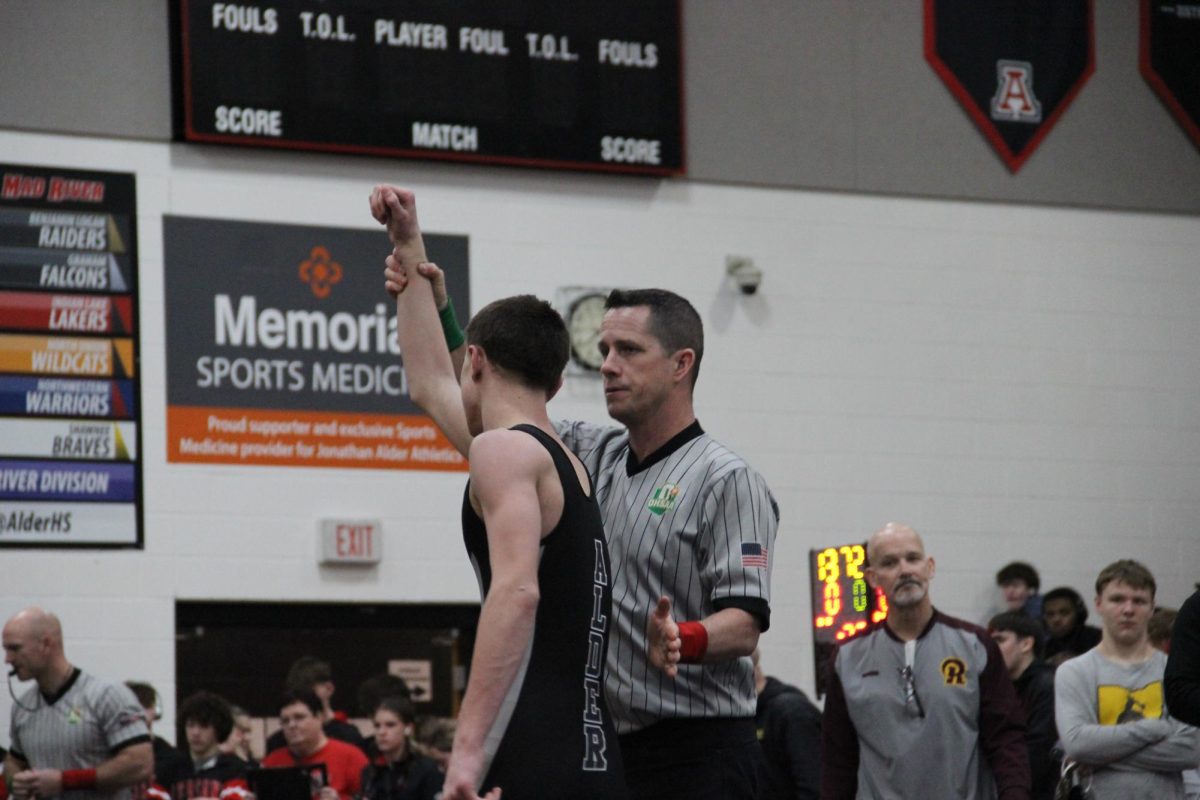 Junior Rayce Watson gets his hand raised after winning his match. 