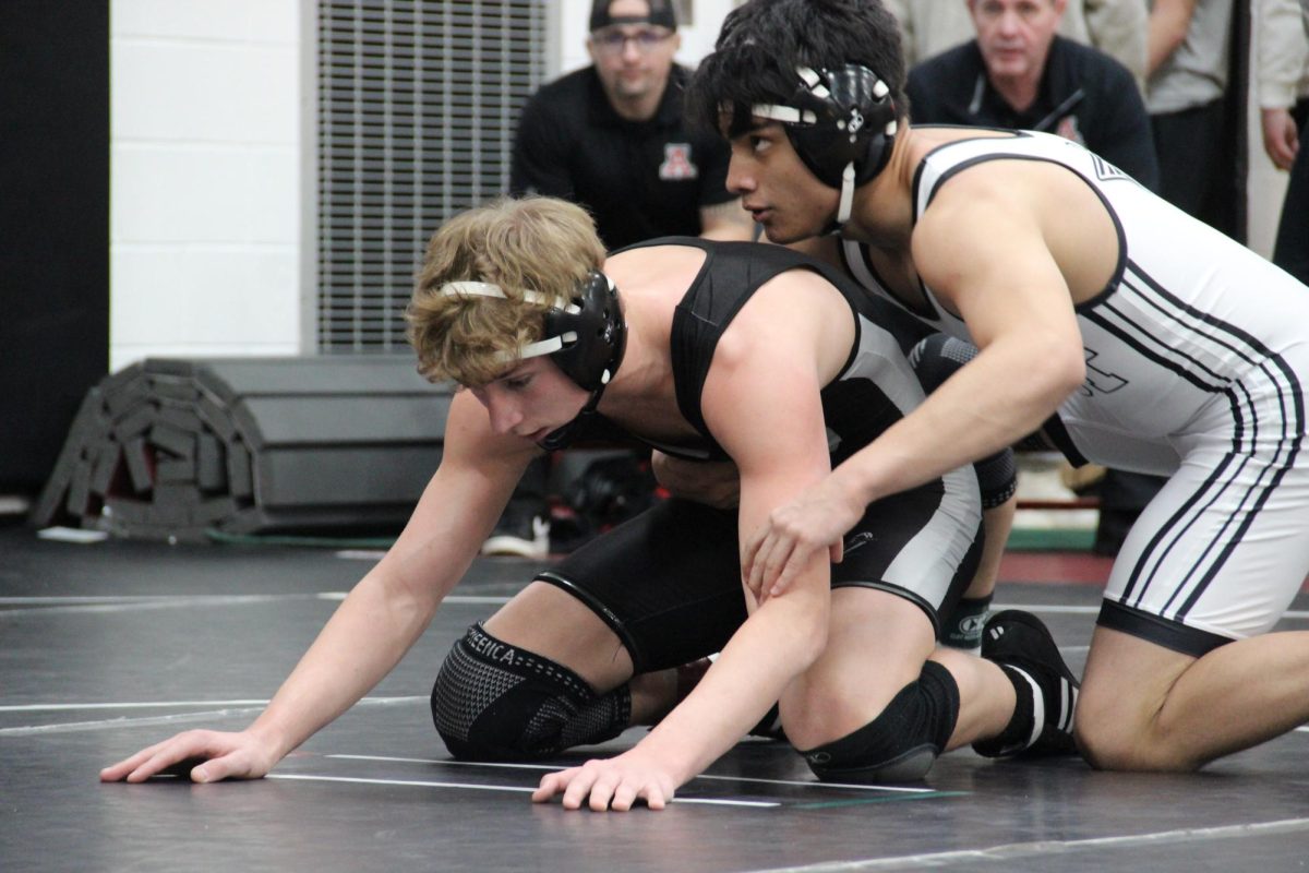 Senior Aiden Ricker wrestles his opponent. 