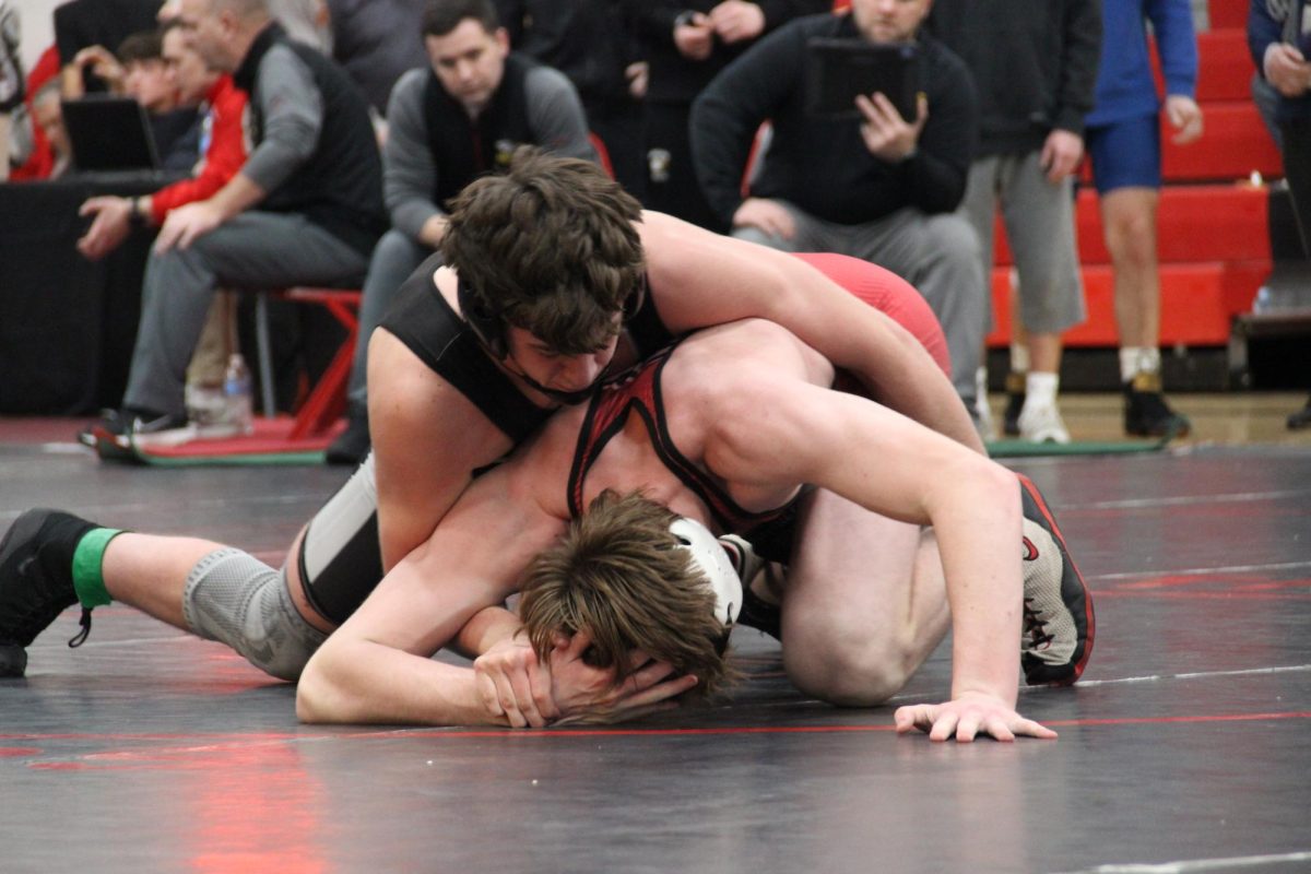 Junior Paul Byerly wrestles his opponent. 