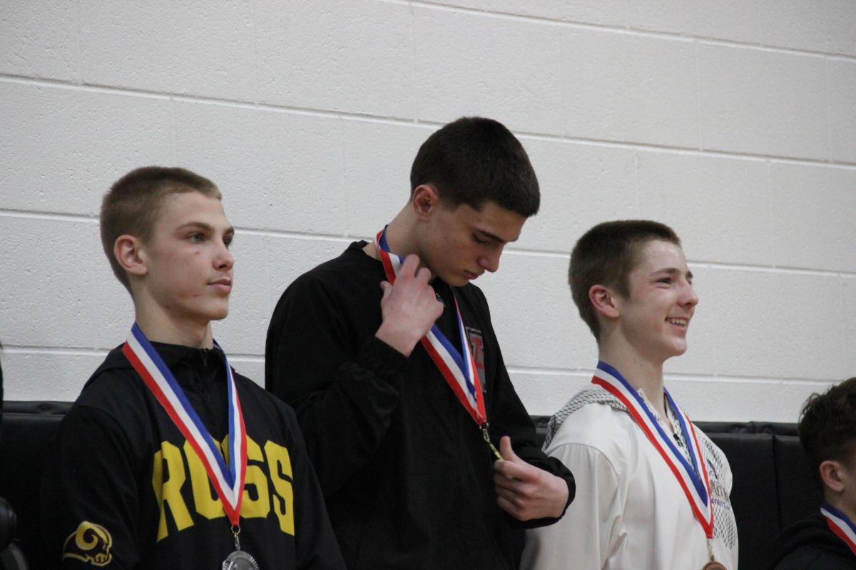 Junior Rayce Watson puts on his first place medal after the tournament. 
