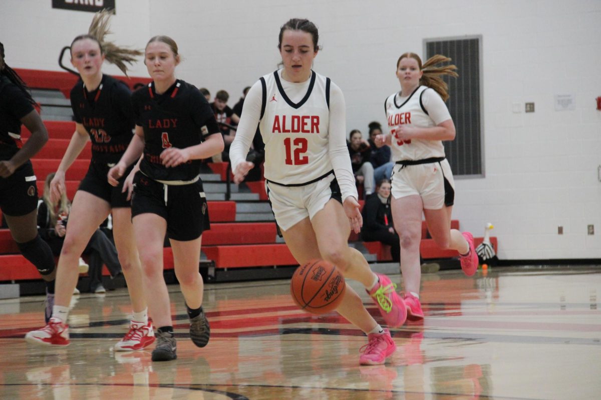 McGrath dribbles towards the hoop.