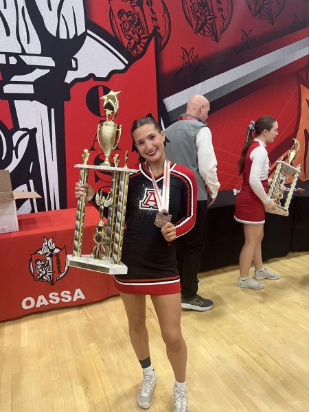 Cara Smith holding her trophy at the state cheer competition.
Photo courtesy of Cara Smith.