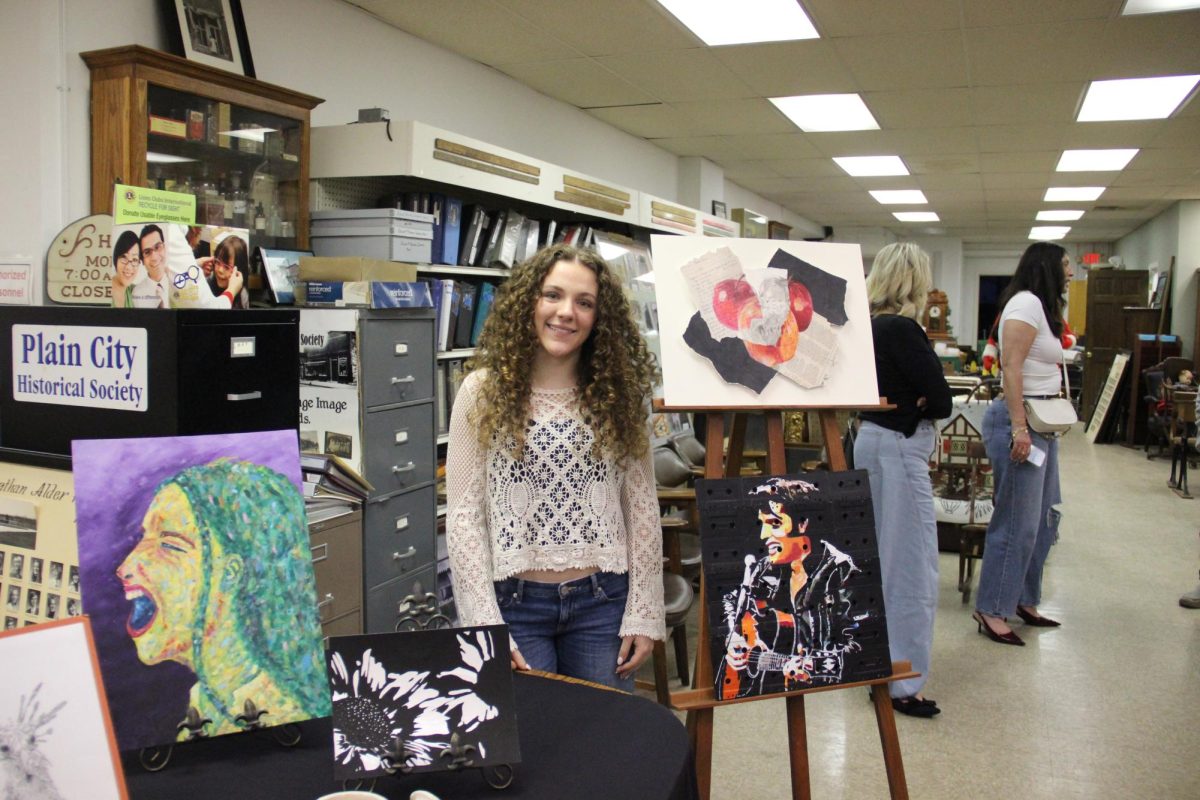 Senior Raegan Tramayne and several of her art pieces.