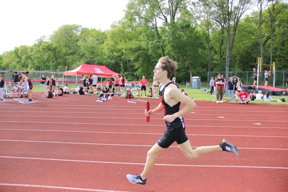 Senior Ian Odell runs the 4x8.