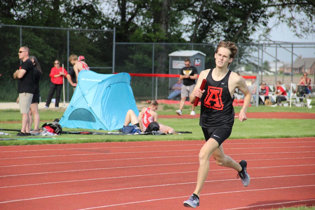 Senior Ian Odell runs the 4x8.