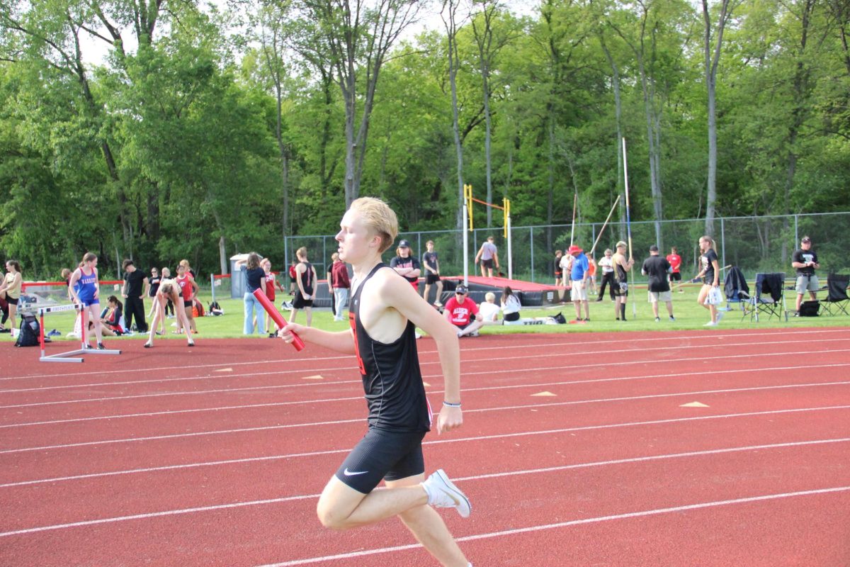 Freshman Jake Goode runs the 4x8.