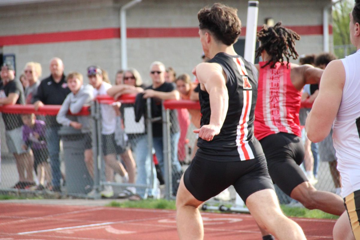 Sophomore Grayson Adams makes it to the finish line in the 100 meter dash.